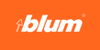 Photo of Blum logo. Orange box with white lettering in middle that says BLUM 