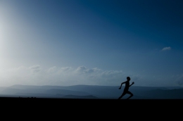 (1) Silhouette of a person running infront of a landscape